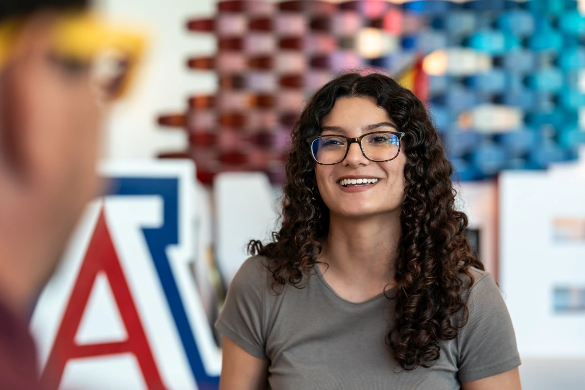 Student smiling in front of Block A.