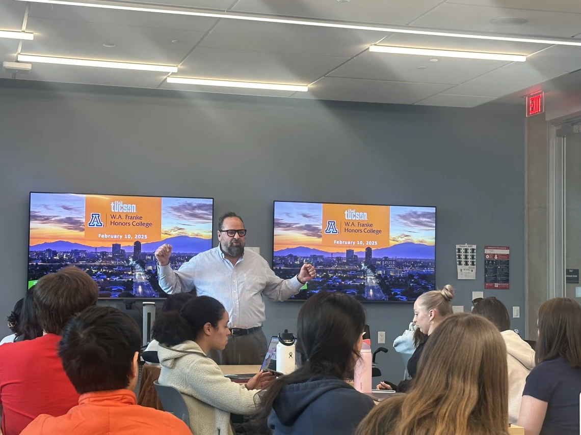 person lecturing to group of students