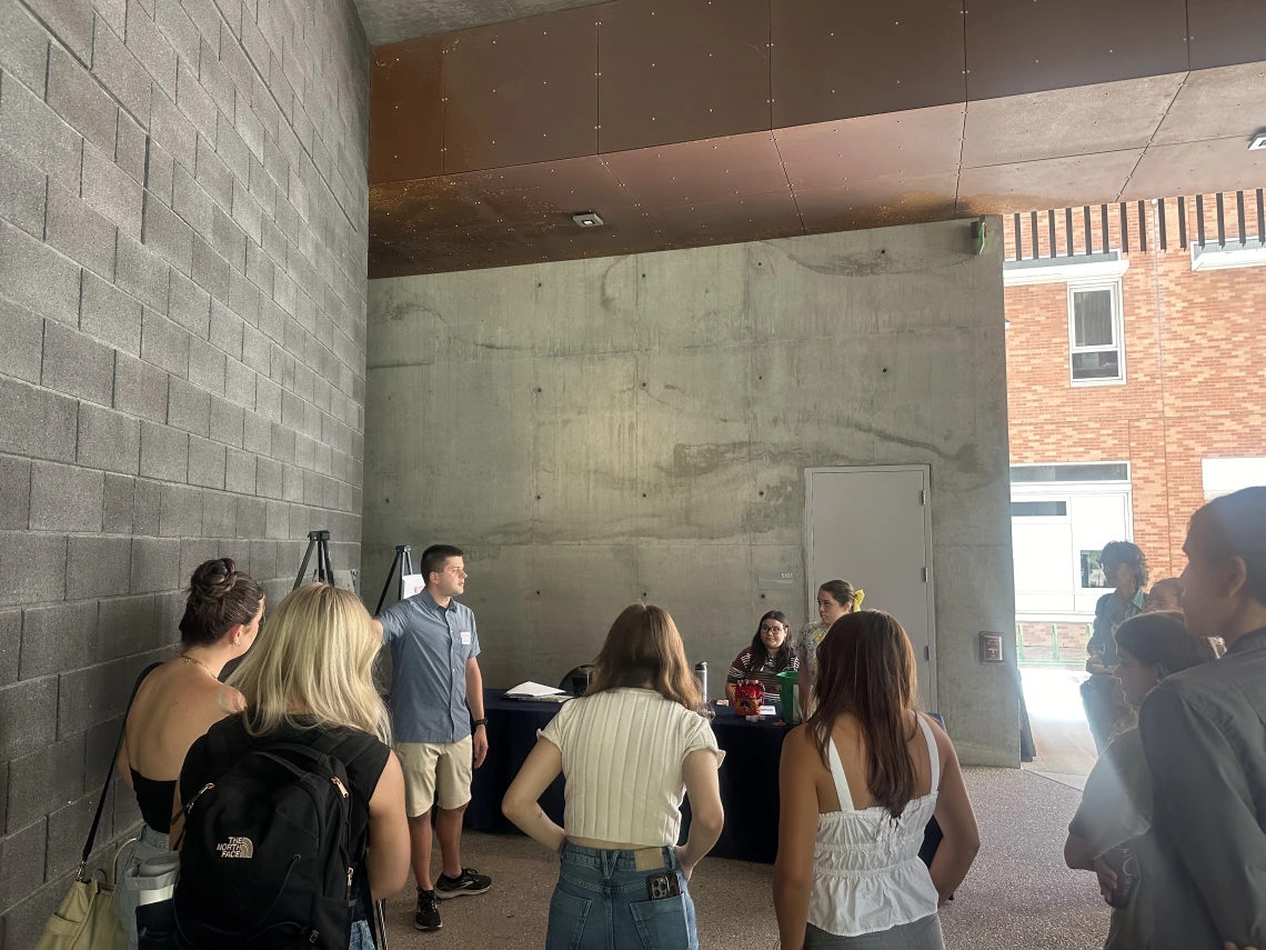 students standing hearing from presentation