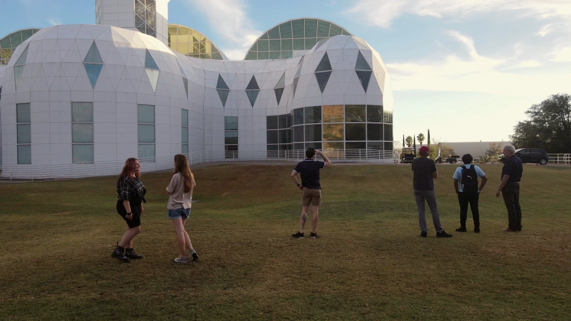 Students outside of Biosphere 2 at dusk