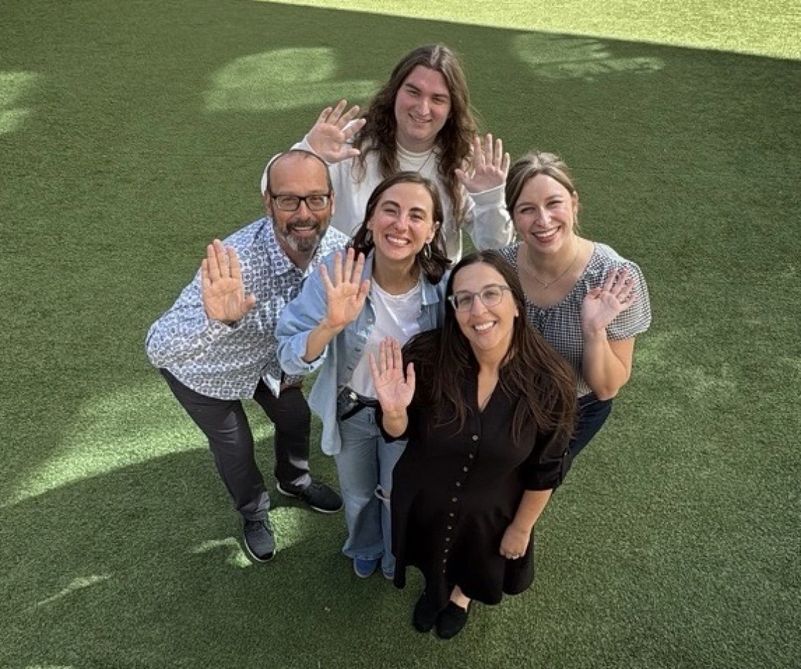 Franke HOnors advisors waving from the Honors Village courtyard