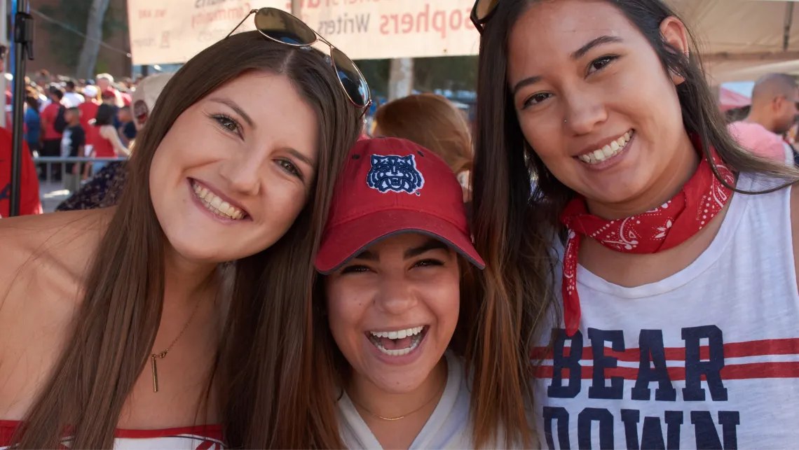 Three really happy students smiling for the camera