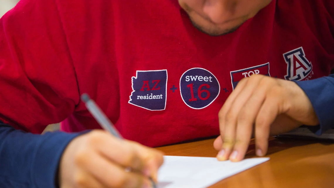 Student signing a contract 