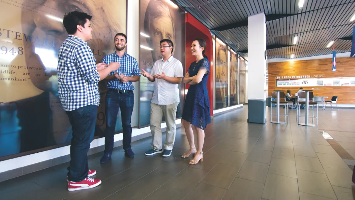 group of students talking in a hall