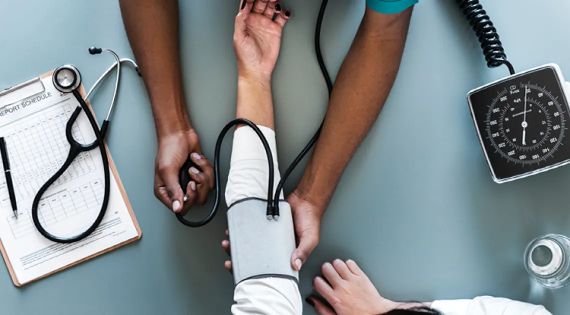 Nurse taking the blood pressure of patient