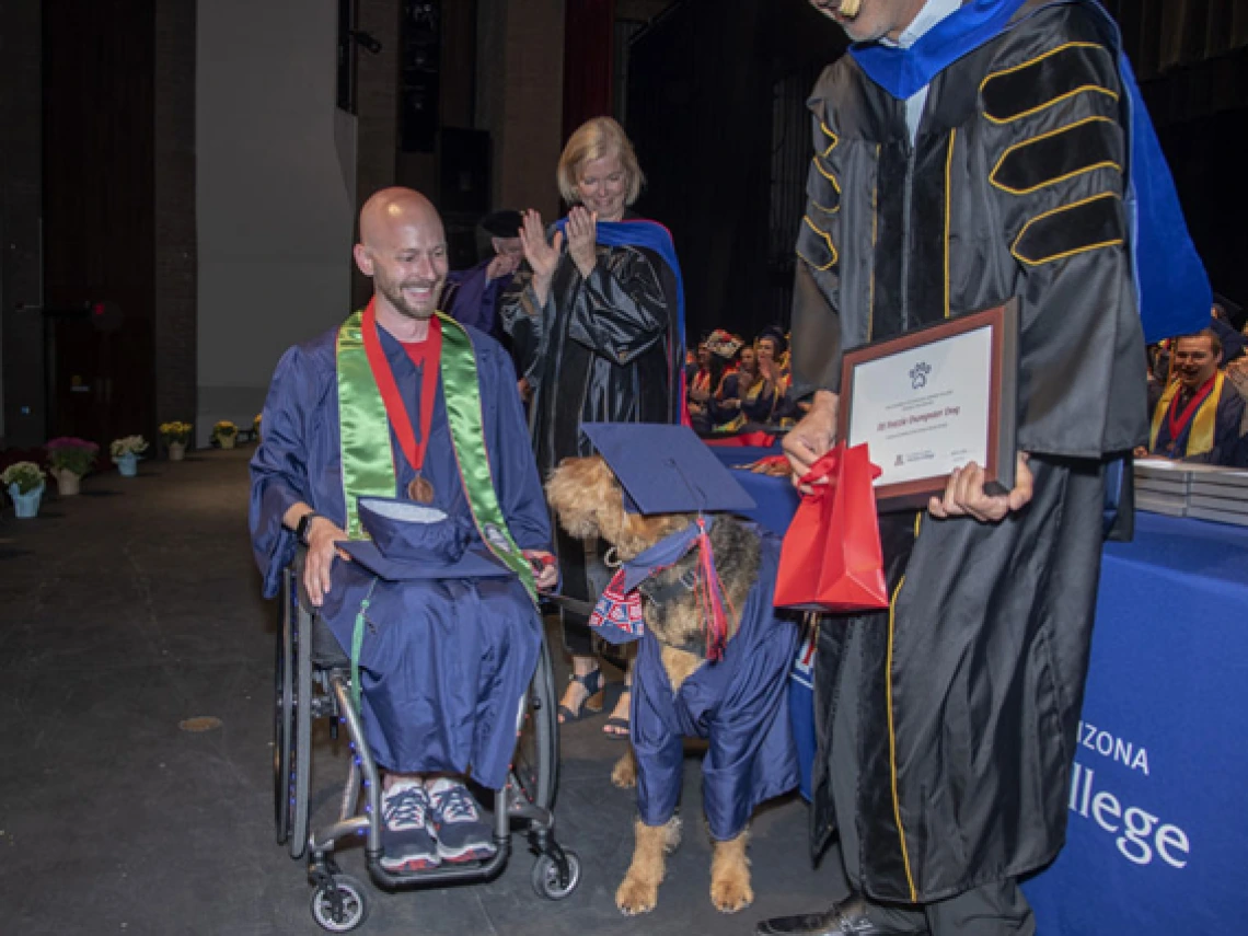 Nick Knapton going across the graduation stage 