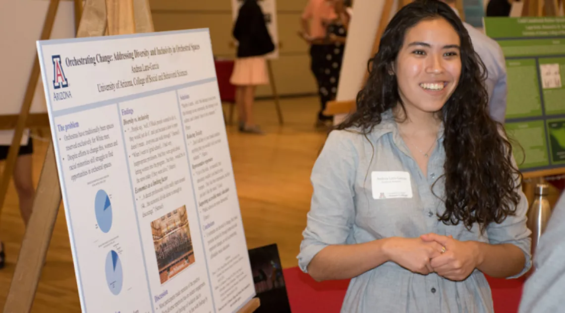 Student showing her research project