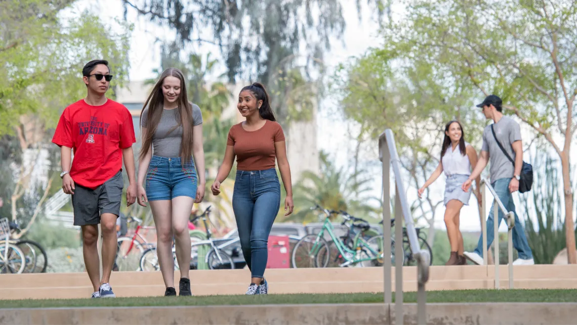 Three students in casual wear walking