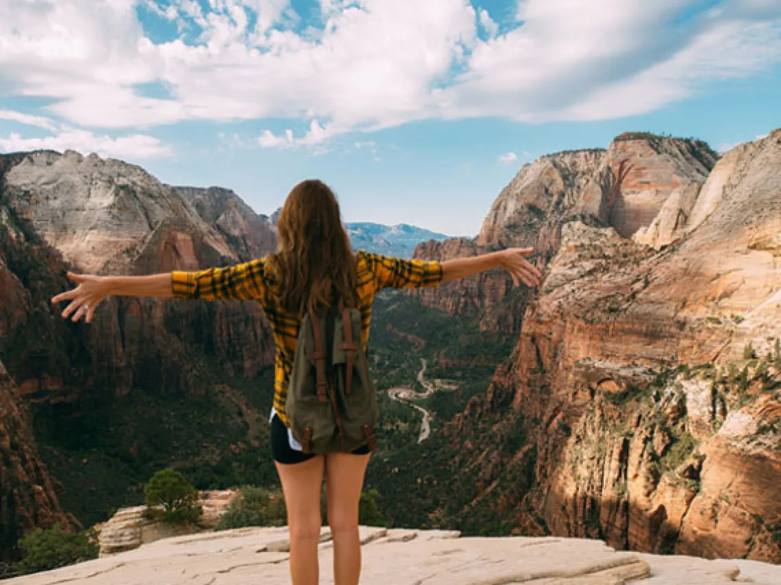 Woman on top of mountain 