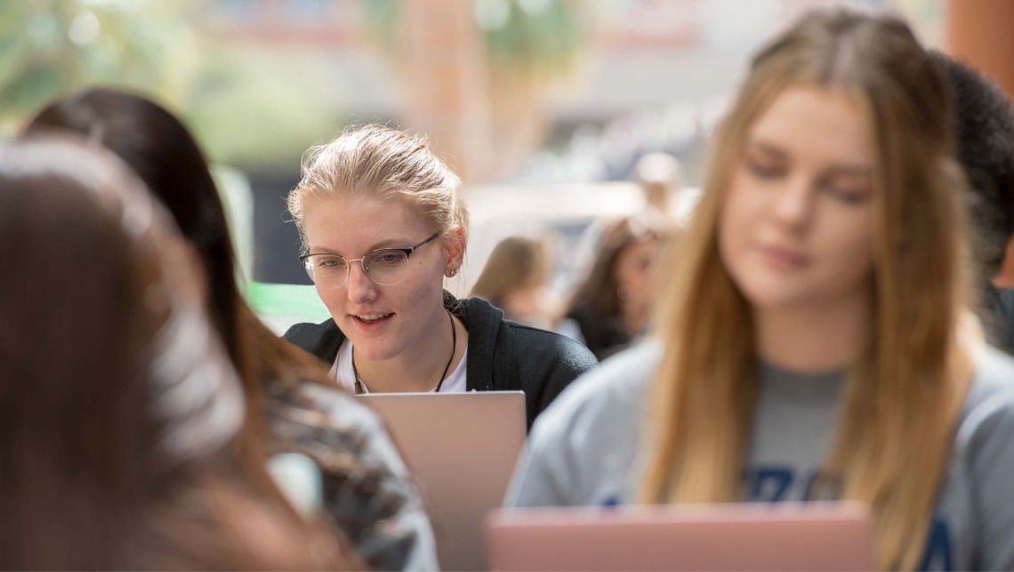 Student on laptop on campus