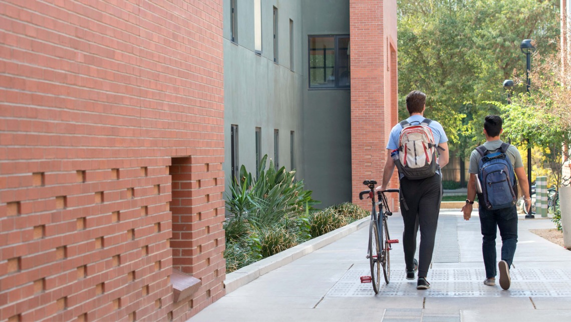 Students walking side by side on campus