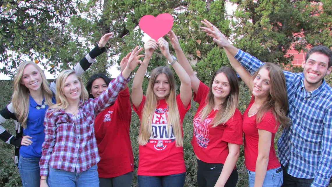 Group of Students gathered around hearts