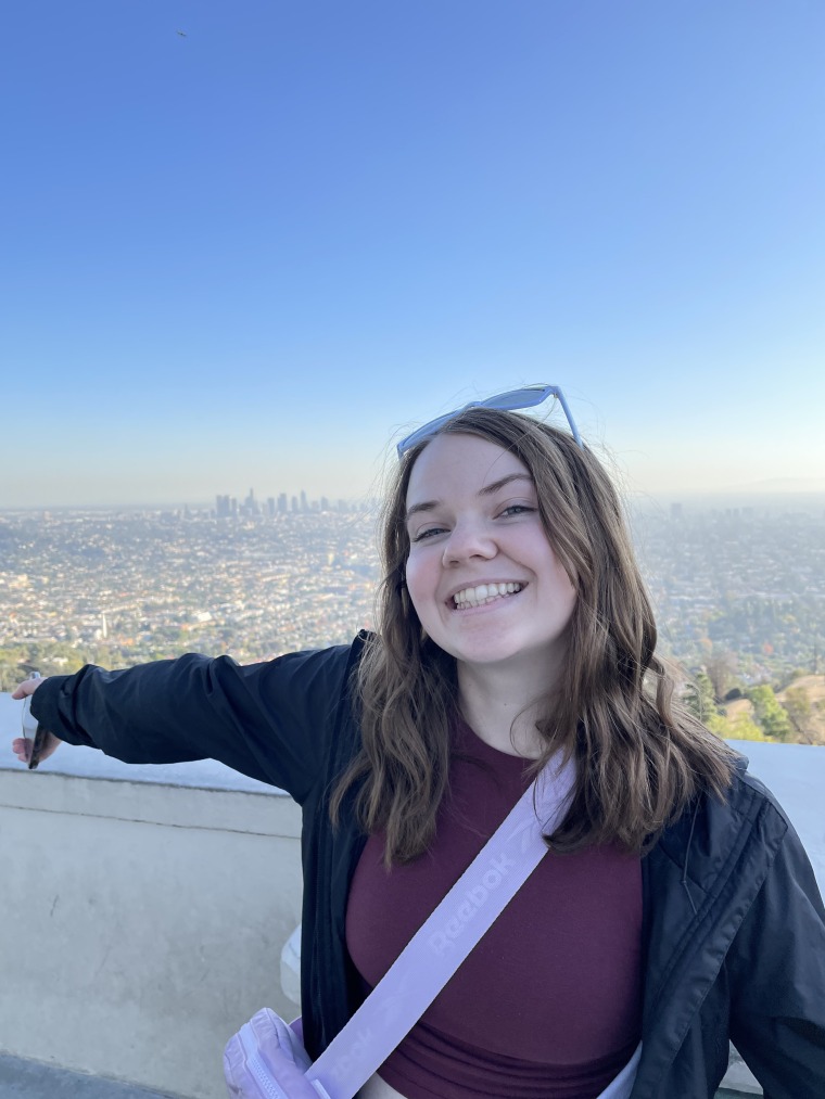 student pictured with city background blue sky
