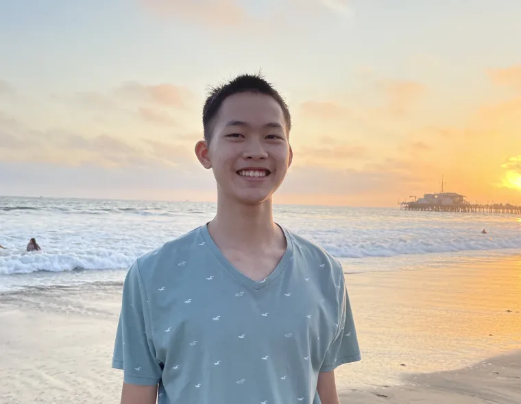 man standing on beach at sunset