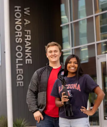 Colin and Nisha in front of the Honors college