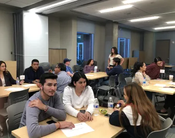 students sitting in classroom having conversation