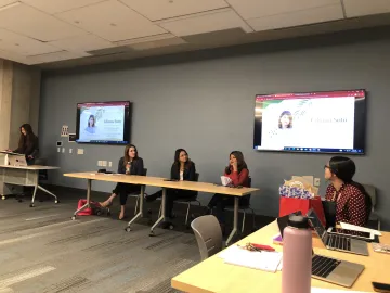 students sitting in classroom having conversation