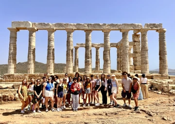 group of students in front of greek ruins