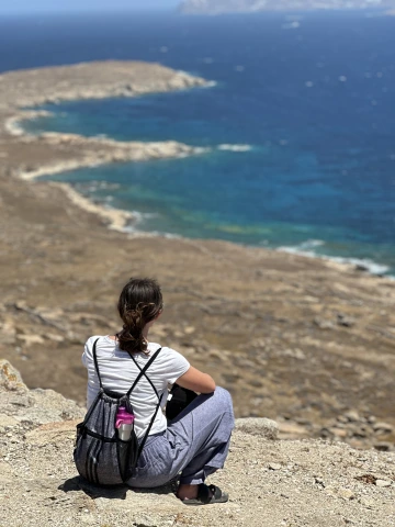 person sitting by ocean 