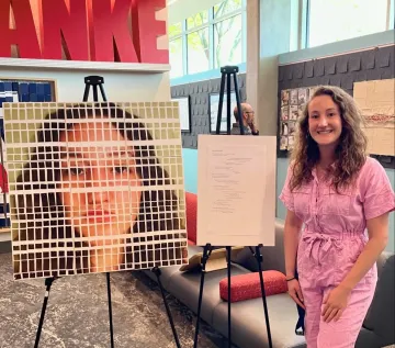 person standing next to poster 