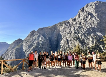 group of students standing in front of rock formations