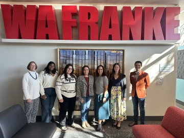 group of people standing in front of WA Franke Letters