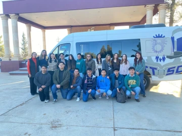 group of students in front of van