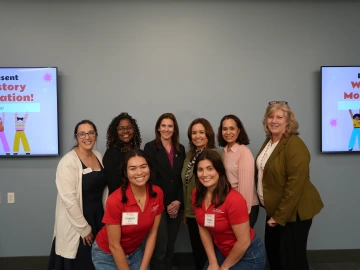 women standing in a group smiling at camera