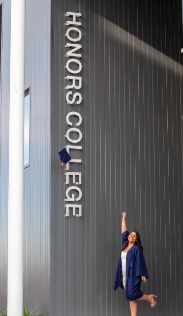 Cap Toss in front of Honors Village