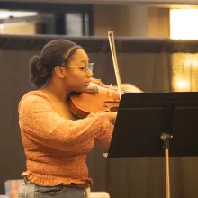 Stephenson playing viola at the banquet