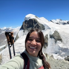 woman pictured in front of snowy mountains