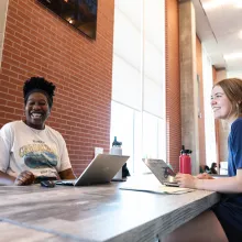 Two students working in the Honors Village Foyer