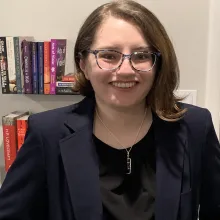 headshot with books in the background