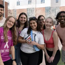 students standing in group smiling at camera