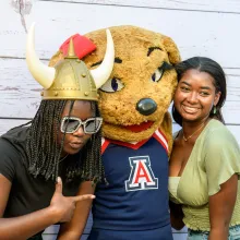 Two students with Wilma Wildcat