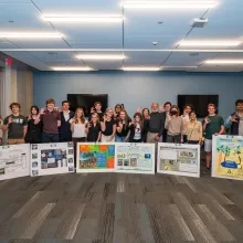 students with posters showing wildcat hand symbol