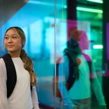 Student walking by mirror wall
