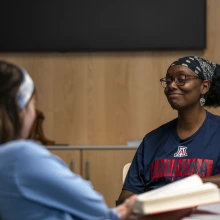 Two students talking in a room