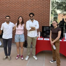 students standing in front of brick wall