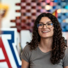 Student smiling in front of Block A.
