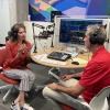 two people sitting in front of podcast equipment