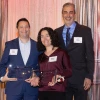 john pollard standing with mark and mindy zeitzer handing them awards