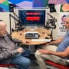 two guests sitting in front of podcast equipment
