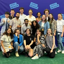 group of people in front of blue background smiling