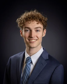 student headshot with dark blue background