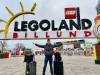 person standing in front of legoland sign